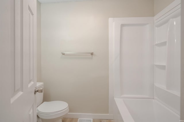 bathroom with walk in shower and toilet