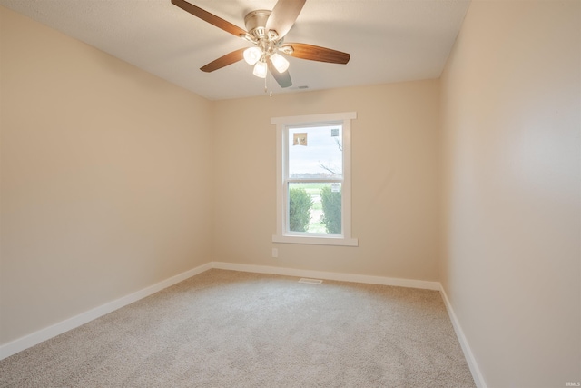 carpeted spare room featuring ceiling fan