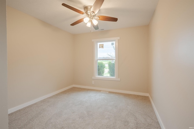 empty room featuring carpet flooring and ceiling fan