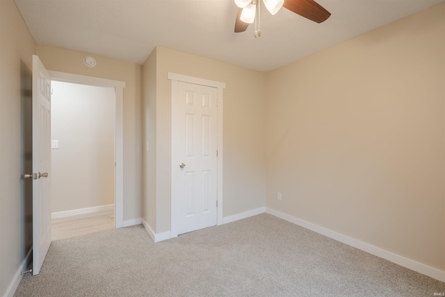 unfurnished bedroom featuring a closet, ceiling fan, and light carpet