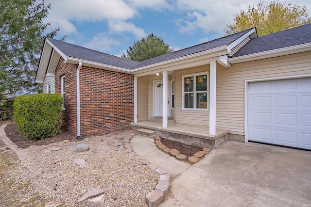 view of front of home featuring a porch and a garage