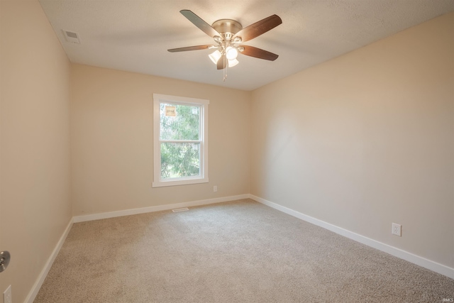 unfurnished room featuring ceiling fan and carpet floors