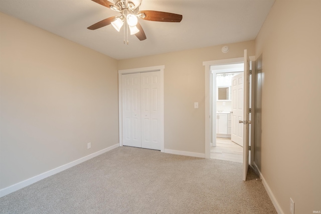 unfurnished bedroom with a closet, ceiling fan, and light carpet