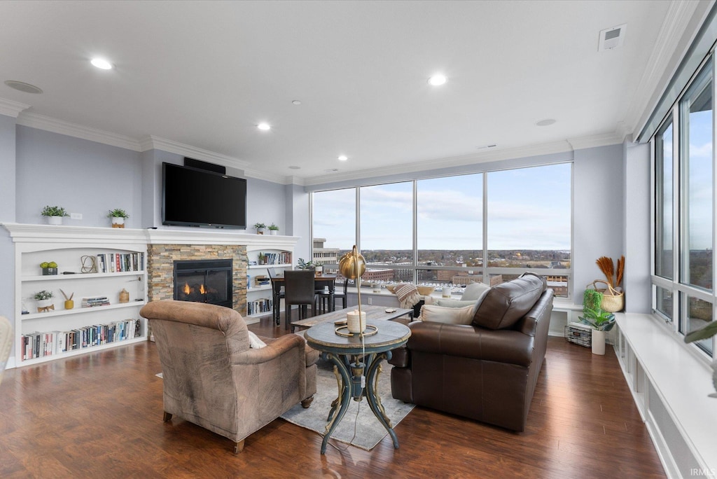 living room with dark hardwood / wood-style floors, plenty of natural light, and crown molding