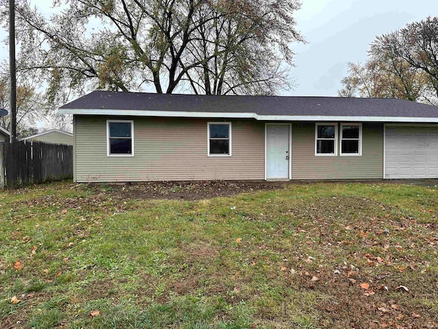 ranch-style home featuring a garage and a front lawn