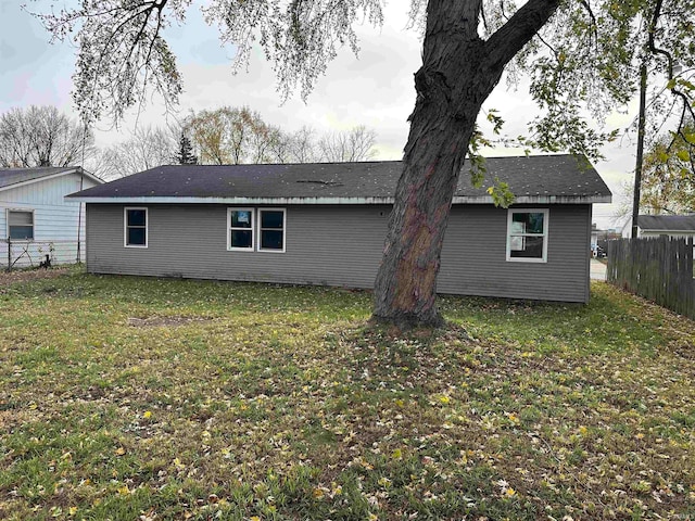 back of house with a lawn