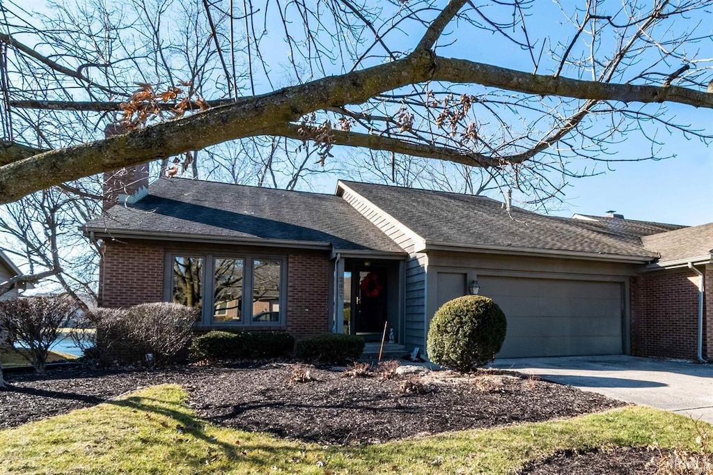 2521 Kingston Pt, Fort Wayne, IN 46815 - ranch-style home featuring a garage, a chimney, brick siding, and concrete driveway