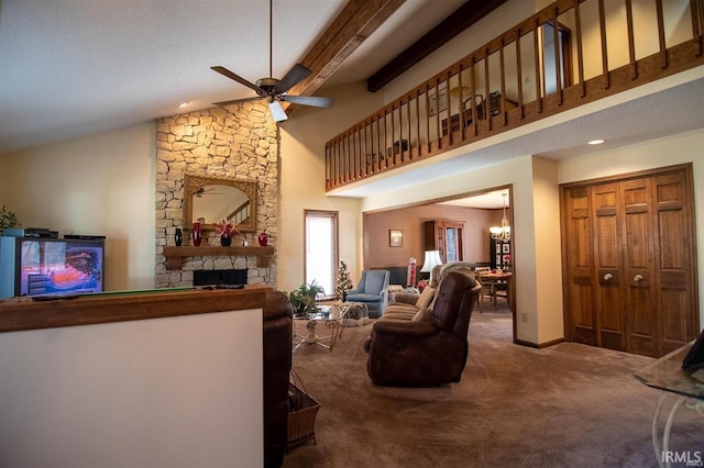 carpeted living room featuring ceiling fan with notable chandelier, a textured ceiling, beam ceiling, high vaulted ceiling, and a fireplace