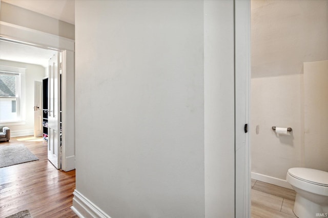 bathroom featuring hardwood / wood-style flooring and toilet