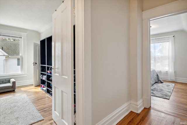 hall with hardwood / wood-style floors