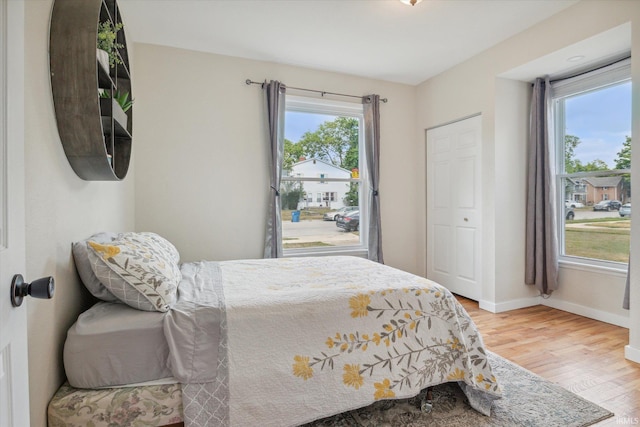 bedroom with hardwood / wood-style floors and a closet