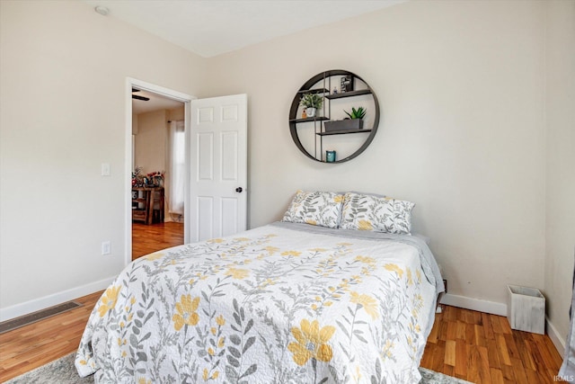 bedroom with hardwood / wood-style flooring