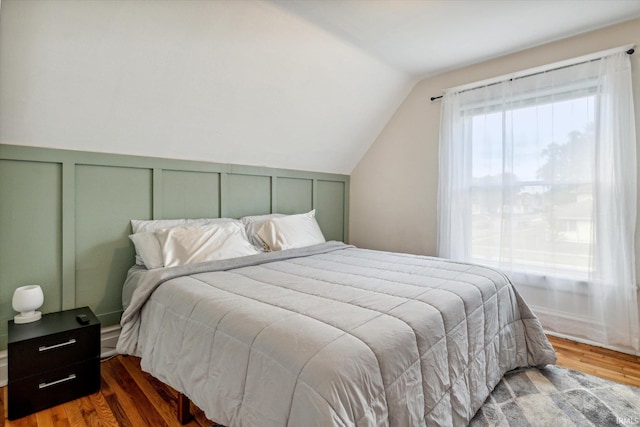 bedroom featuring dark hardwood / wood-style floors and vaulted ceiling