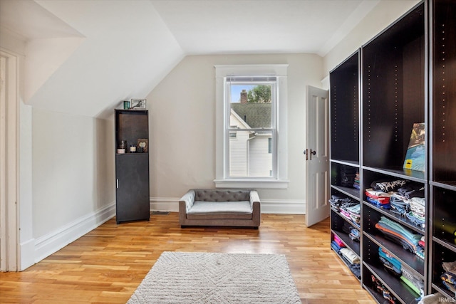 sitting room with vaulted ceiling and light hardwood / wood-style flooring