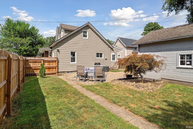 rear view of house featuring a yard