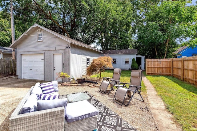 view of patio featuring an outbuilding and a garage