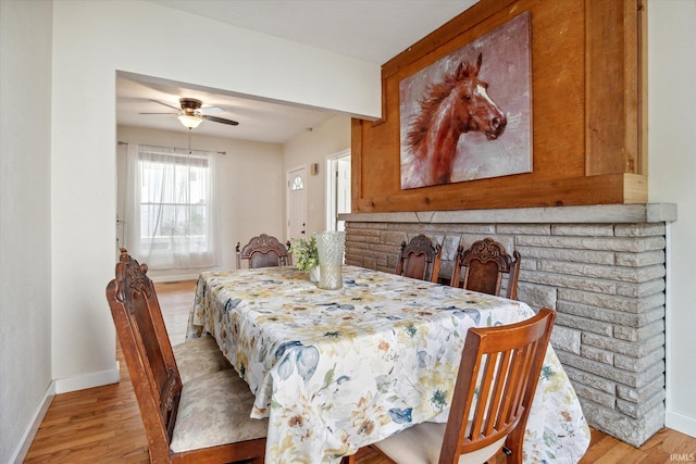 dining area with ceiling fan and light wood-type flooring