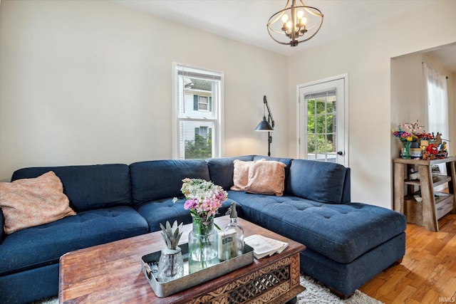 living room featuring a chandelier and light hardwood / wood-style flooring