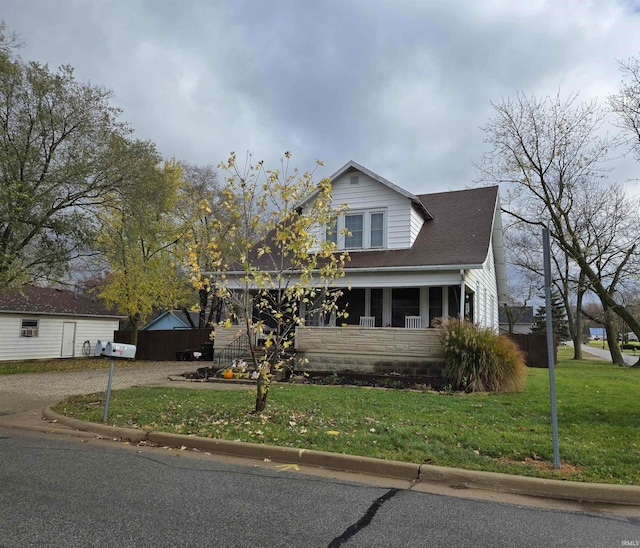 bungalow featuring a porch and a front lawn