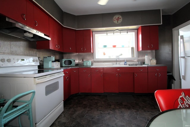 kitchen featuring sink, white appliances, and backsplash