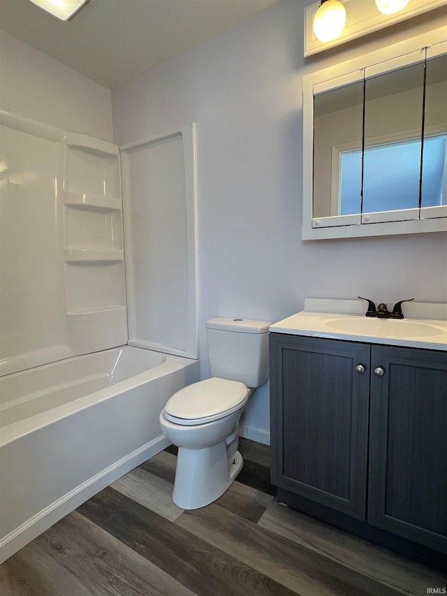 full bathroom with vanity, toilet, wood-type flooring, and shower / tub combination