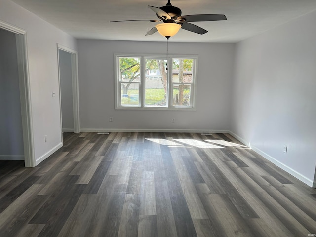 unfurnished room with dark hardwood / wood-style floors and ceiling fan