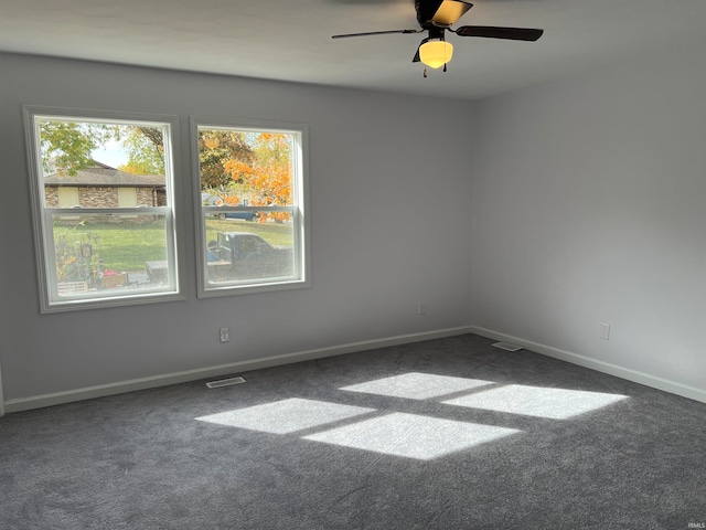 carpeted spare room with ceiling fan