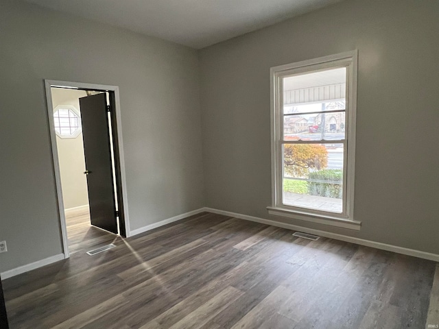 spare room with dark hardwood / wood-style floors