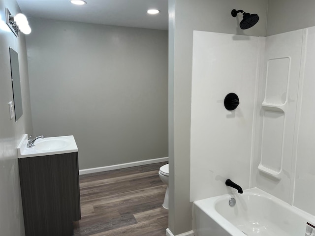 full bathroom with shower / bathing tub combination, hardwood / wood-style floors, vanity, and toilet