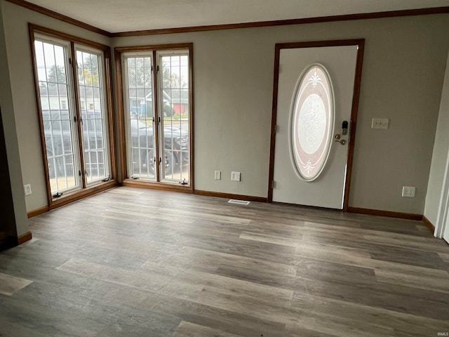 entrance foyer featuring crown molding and light hardwood / wood-style flooring