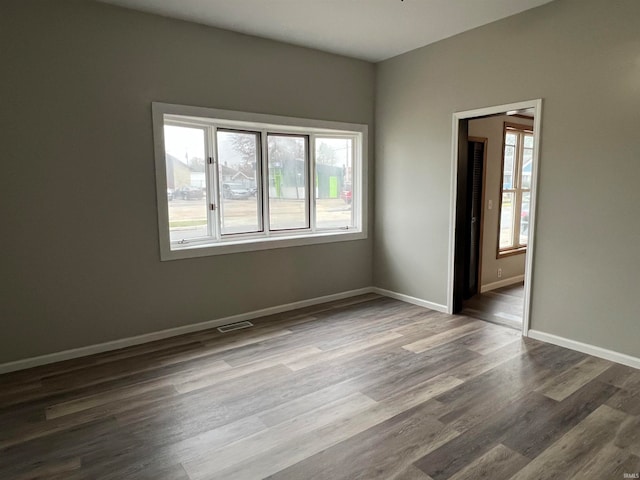 spare room featuring dark hardwood / wood-style floors