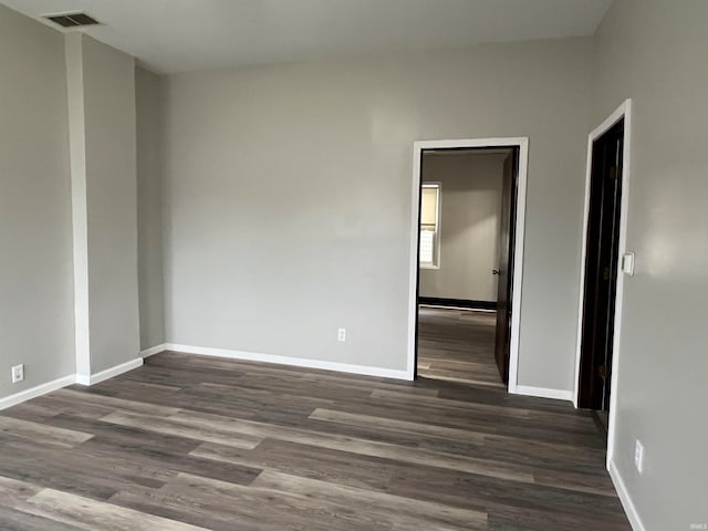 empty room featuring dark hardwood / wood-style flooring