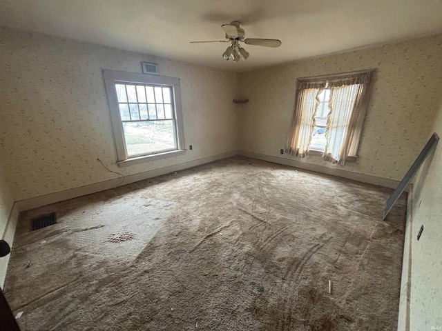 spare room with carpet and ceiling fan