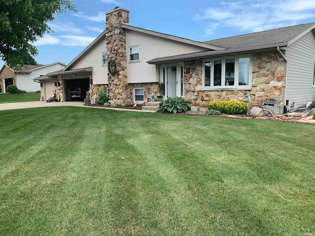 split level home featuring a front yard and a garage