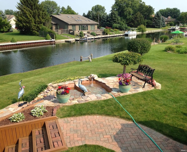 surrounding community featuring a water view and a patio