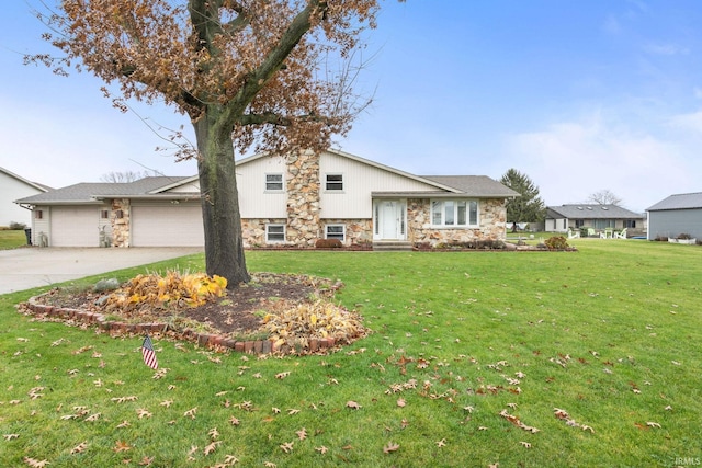 split level home with a front yard and a garage