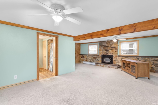 living room featuring light carpet, ceiling fan, a baseboard heating unit, beam ceiling, and a wood stove