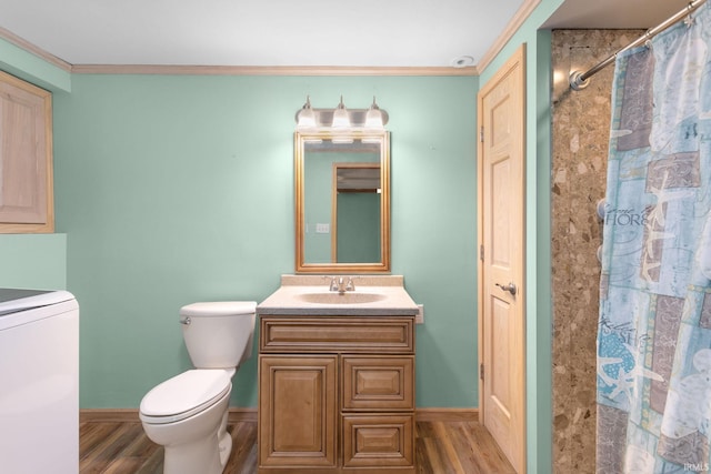 bathroom featuring toilet, washer / dryer, wood-type flooring, and ornamental molding