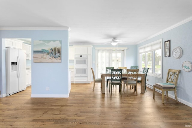 dining space with crown molding, ceiling fan, and wood-type flooring