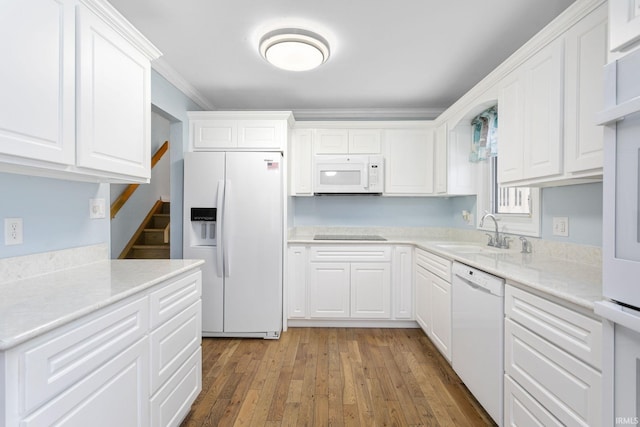 kitchen featuring white cabinetry, white appliances, and sink