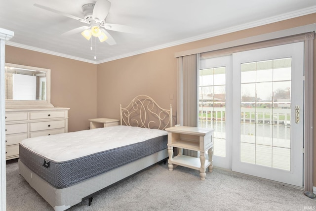 carpeted bedroom featuring access to exterior, ceiling fan, and crown molding