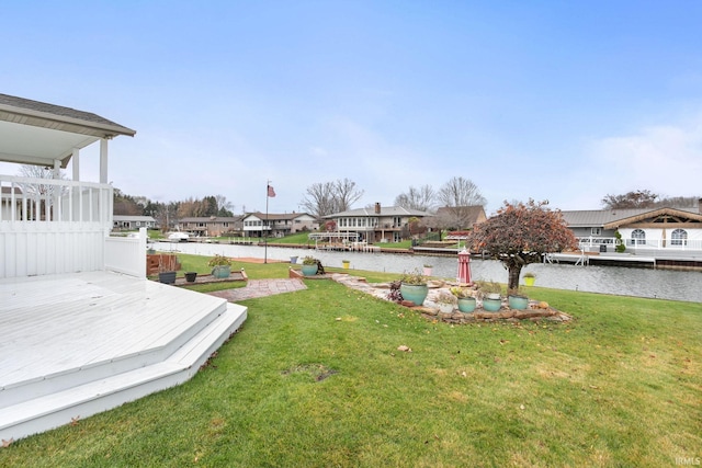 view of yard with a deck with water view