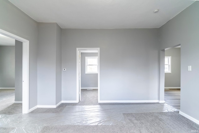 unfurnished room with light colored carpet