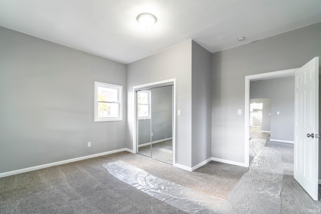 unfurnished bedroom with carpet flooring and a closet