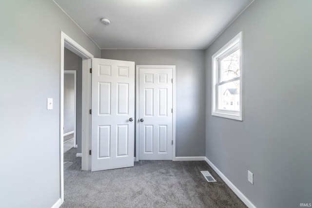 unfurnished bedroom featuring carpet and a closet