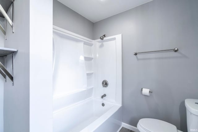 bathroom featuring shower / bathing tub combination and toilet