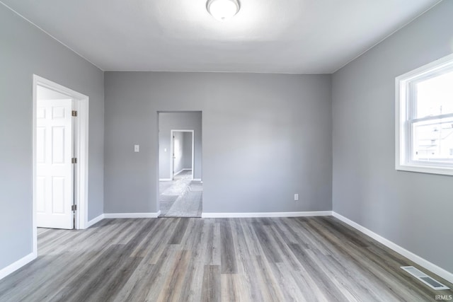 empty room with light hardwood / wood-style flooring