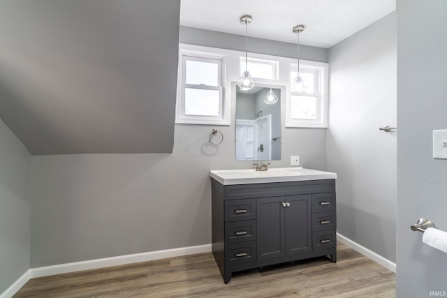 bathroom with hardwood / wood-style floors, vanity, and a healthy amount of sunlight