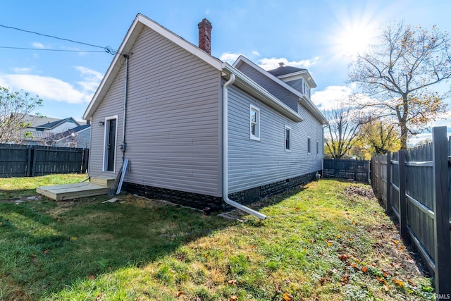 view of home's exterior with a lawn and a wooden deck