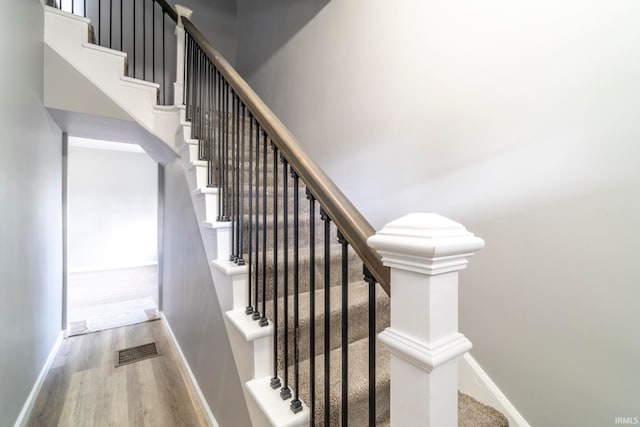 stairs with hardwood / wood-style flooring